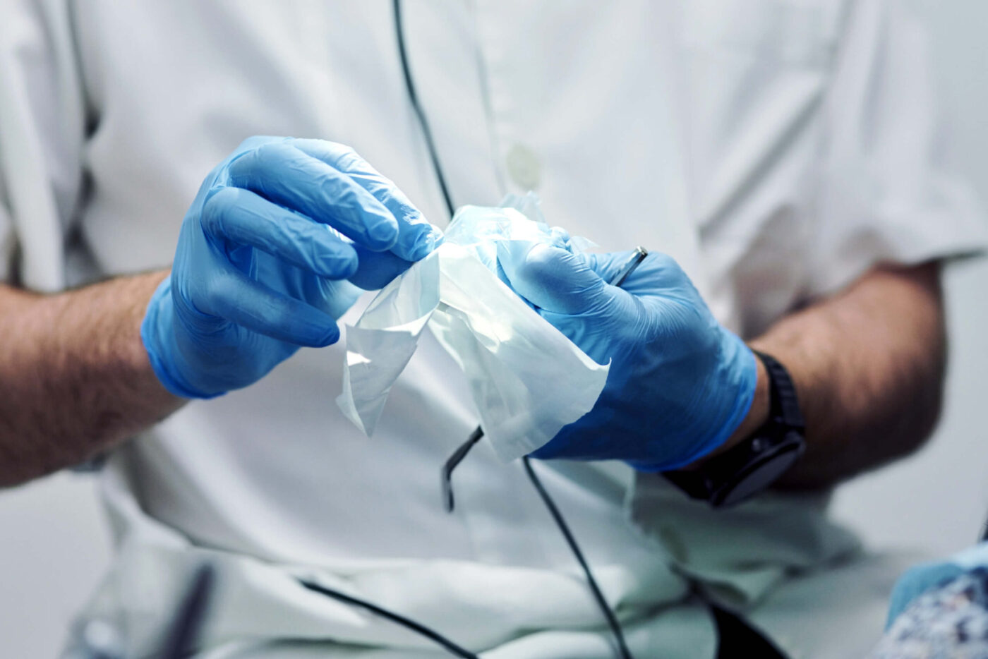 Man in medical gloves cleaning some plastic