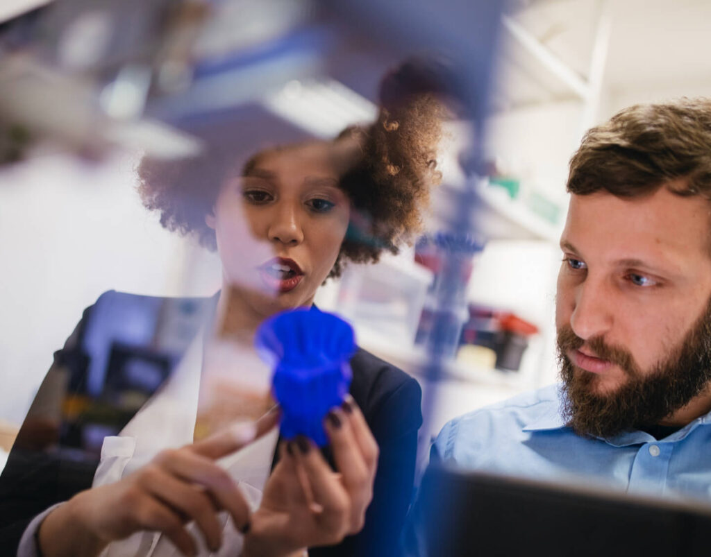 Two people looking at a product and collaborating