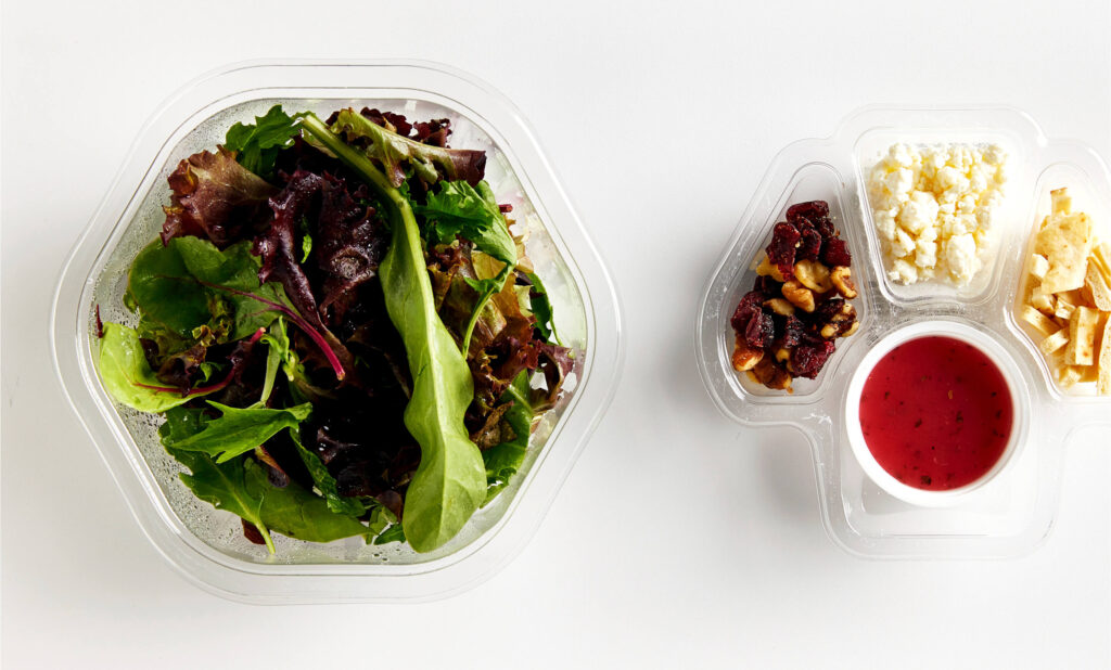 custom thermoformed food packaging showing a salad with fixings
