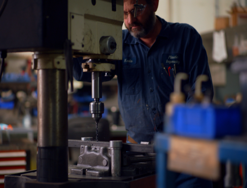 Plastic Ingenuity Team Member making tool improvements