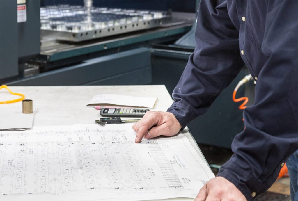 Plastic Ingenuity Employee Working on Drafting Table